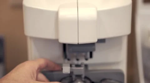Optician testing lenses with a professional optical equipment Video stock 56570506