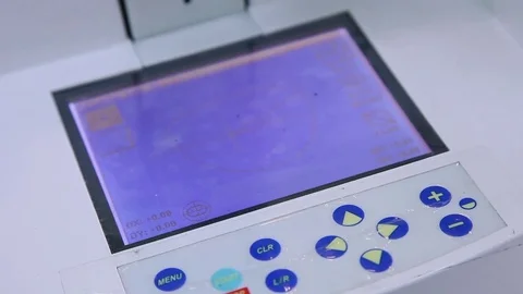 Optician using machine in glasses lens Stock Footage 72445224