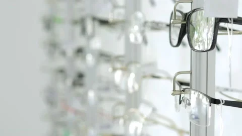 An optics store with many different glasses. Glasses are on the shelves for sale Stock Footage 159480686