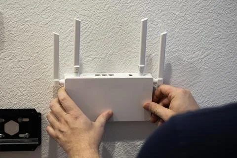 For optimal connectivity, installing a wireless router on the wall can enha.. Stock Photos