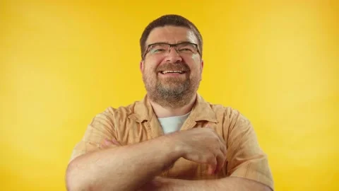 Optimistic 40s man sincerely laughing against orange background, happiness Stock Footage 157400628