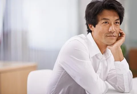 Optimistic about the future. a handsome asian businessman looking thoughtful Stock Photos