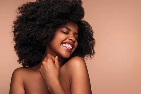 Optimistic black model touching neck Stock Photos