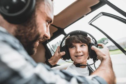 Optimistic child talking with glad pilot indoor Foto stock