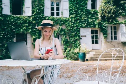 Optimistic female worker using phone for working Stock Photos