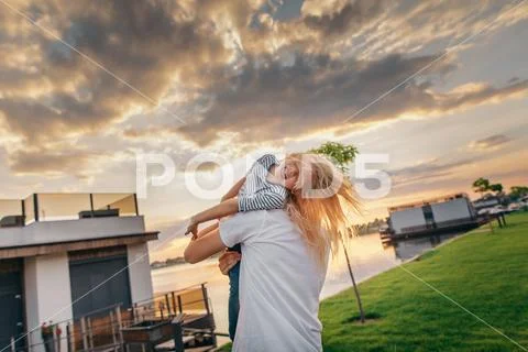 Optimistic kid entertaining with male during evening Stock Photos