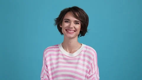 Optimistic lady beaming smiling in camera isolated blue color background Stock Footage 169707822