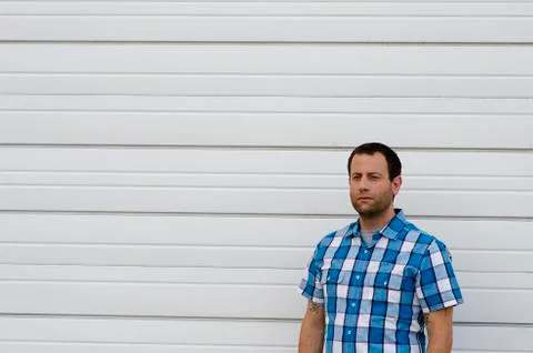Optimistic man outdoors with a white background. Stock Photos