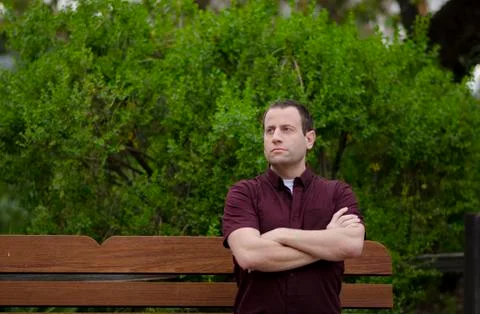 Optimistic man sitting on a bench. Foto stock