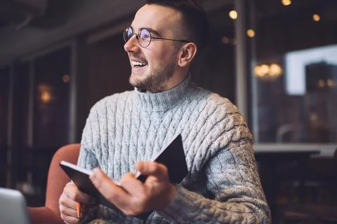 Optimistic man writing notes in notebook Stock Photos