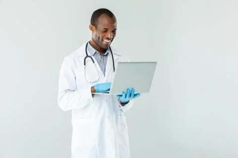 Optimistic professional doctor using his laptop Stock Photos
