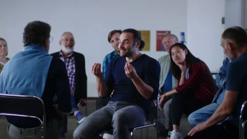 Optimistic reformed addict talking about life without alcohol during AA meeting Stock Footage 157073751