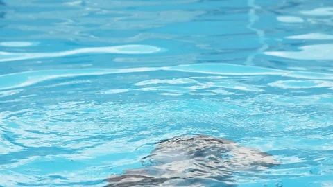 Optimistic woman emerging in a swimming pool with celeste waters in slo-mo Stock Footage 119232353