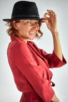 Optimistic woman in hat posing at camera Stock Photos