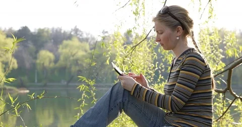 Optimistic Woman Work On Digital Tablet In Nature Girl Sitting Trunk View Lake Stock Footage 72777317