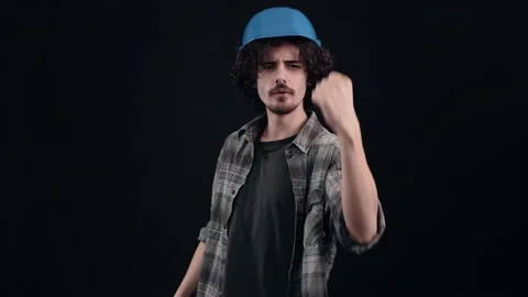 The optimistic young man with the blue engineer's helmet shakes hands happily Stock-Footage 155843348