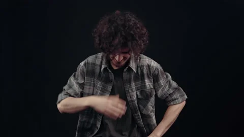 The optimistic young man laughs out loud with his hand on his stomach, pointing Stock Footage 152657114