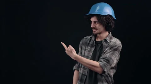 The optimistic young man points to the right, the cheerful sign looks cheerful Video stock 155843536