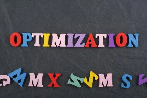 OPTIMIZATION word on black board background composed from colorful abc alph.. 스톡 사진