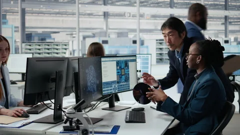 Optimizing microchip production, AI and senior manager with woman in factory Stock Footage 335879545