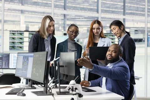 Optimizing PCB production, collaboration and multiethnic engineering team Stock Photos