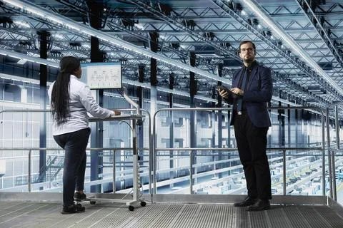 Optimizing production lines workflow, software and team of factory executives Stock Photos
