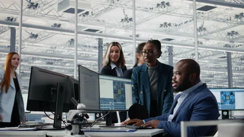 Optimizing production, microchip and multiracial men with women in factory Stock Footage 335879377