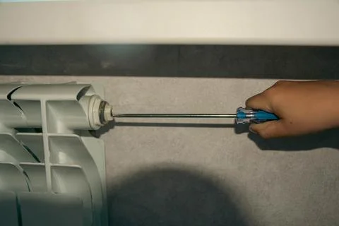 Optimizing Radiator Performance: Air Discharge from Heating Systems in Apar.. Stock Photos