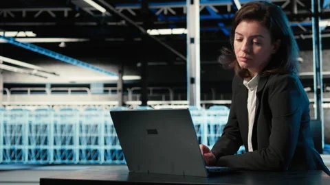 Optimizing server, laptop and software developer in data center Stock Footage 329333484