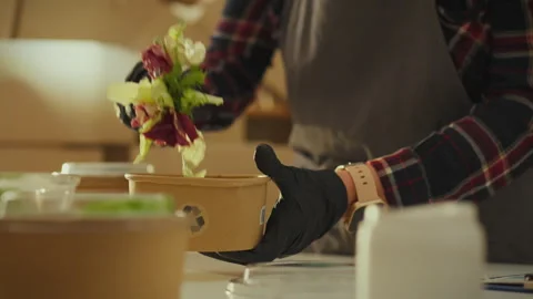 Optimizing the use of resources. An employee prepares orders for the deliver Stock Footage 266156387