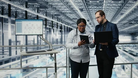 Optimizing workflow, microchips and woman with coworker using EDA software Stock Footage 333380015