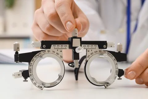 Optometrist adjusting a trial frame for an eye exam, vision correction and he Stock Photos