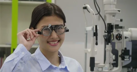 Optometrist gives pair of optometry glasses to asian women. Video stock 90817015