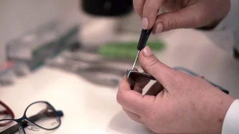 Optometrist hand close up while fixing glasses Stock Footage 70677729