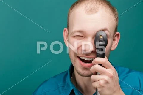Optometrist with ophthalmoscope, instrument to look into eyes by doctor on blue Stock Photos