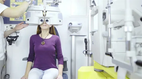 Optometrist put optometry device over woman eyes 4K Stock Footage 59820996
