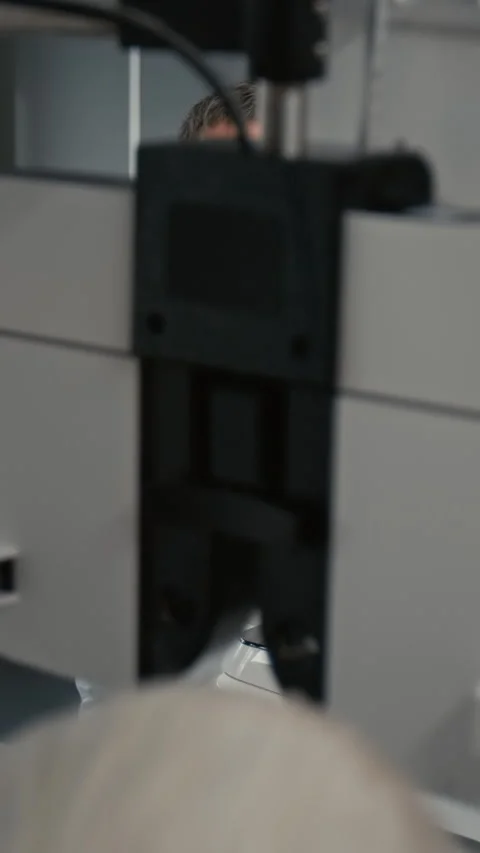 Optometrist using Machine For Eye Test Vertical Stock Footage 322778294