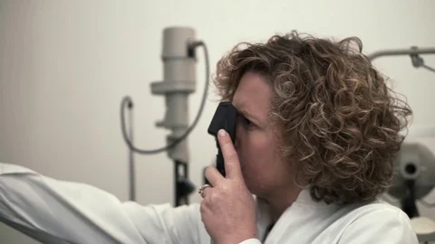 Optometrist visiting his patience with optical professional equipment Stock Footage 70685109