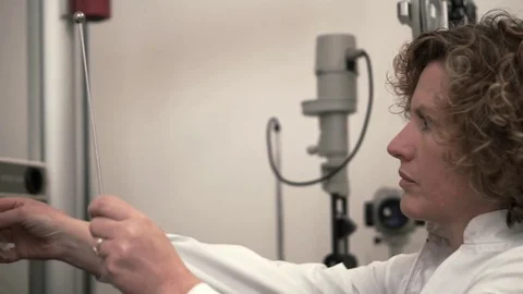 Optometrist visiting his patience with optical professional equipment Stock Footage 70685382