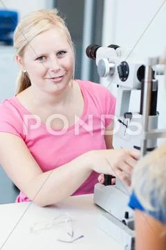 Optometry concept - pretty, young female patient having her eyes Stock Photos