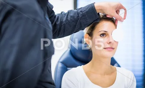 Optometry concept - pretty young woman having her eyes examined Stock Photos