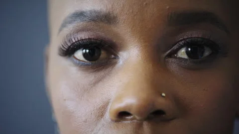 Optometry, eye care and face of black woman in studio with contact lenses for Stock Footage 331335867