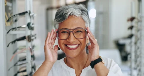 Optometry, glasses and face of senior woman in a clinic for vision, eye care or Stock Footage 255384864