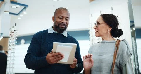 Optometry, man or tablet in store for consulting, digital lookbook and advice on Stock Photos