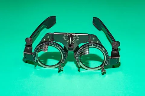 Optometry optics test glasses on a green table. Stock Photos