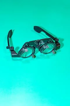 Optometry optics test glasses on a green table. Stock Photos