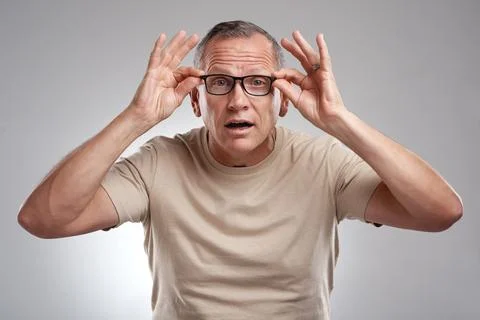 Optometry, portrait or man in studio with glasses, optical surprise or glau.. Stock Photos
