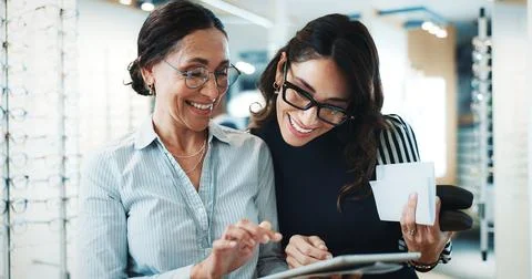 Optometry, tablet and help with women in store for consulting, glasses advice Stock Photos