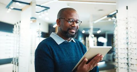 Optometry, typing and man on tablet for store inventory, stock and checklist for Stock Photos