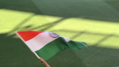 Optus Stadium India Flag waved by fan's hand on stick over cricket ground grass Stock Footage 303791396